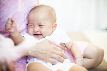 Asian baby happy in the room.Asian baby girl lying down on bed .