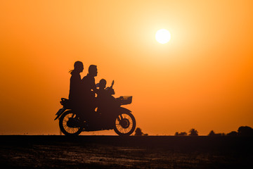 Fototapeta na wymiar Family riding a motorcycle