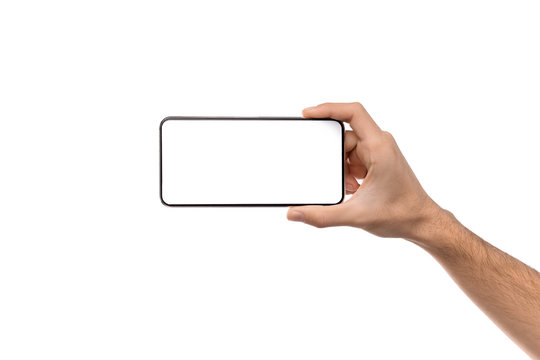 Man's hand holding modern smartphone with blank screen for mockup