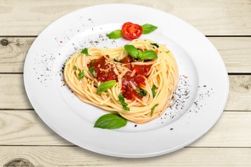 Spaghetti pasta with tomatoes and parsley on  table.
