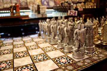 Chess set for sale in front of the store. Made of wood and metallic materials.