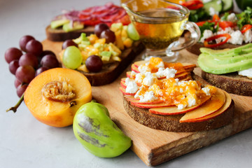 Useful sandwiches stuffed with avocado, scrambled eggs, cottage cheese and fruit