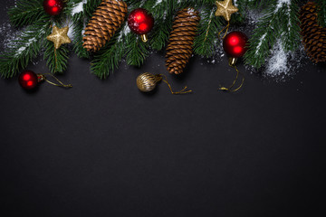 Christmas background with decorations on black.