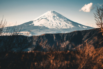 Naklejka premium Beautiful Fuji mountain with snow covered on the top in the winter season in Japan, Teal and Orange tone.
