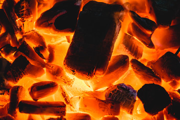 Burning and glowing charcoal with open hot flame