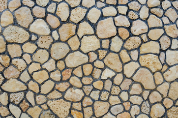 A wall of stones of different shapes and colors.