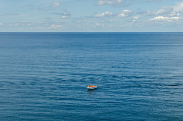 A lifeboat with people in the open sea.