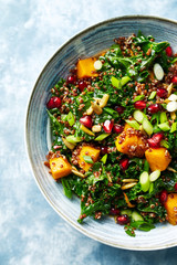 Hokkaido pumpkin and quinoa salad with kale, pomegranate, spring onion and toasted sunflower seeds. Healthy homemade food. Vegan food