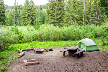 Campsite with tent and picnic table with grill in Albion Basin, Utah summer in Wasatch mountains...