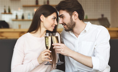 Falling in love couple drinking champagne and looking at each other