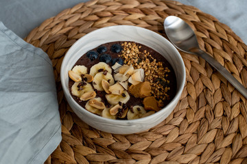 acai bowl served with bananas, blueberries, peanut butter and raw buckwheat granola