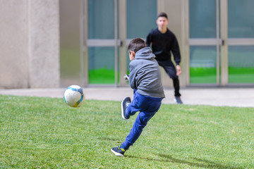 children play football outdoors