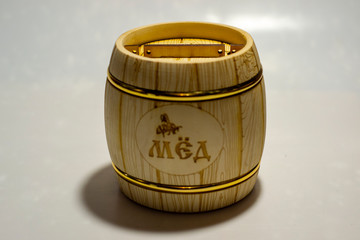 wooden barrel under honey on a white background