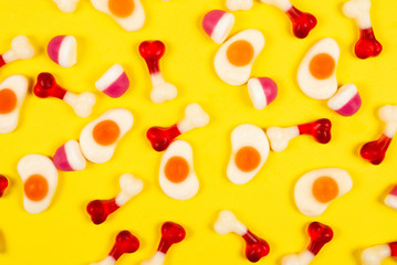Assorted jelly sweets on yellow background. Pattern.