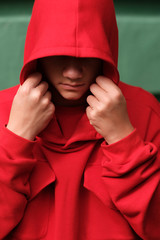 teenage boy wearing fashionable red hoodie