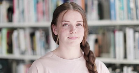 Portrait of high school student in library - Powered by Adobe