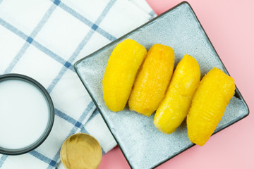 Boiled banana in syrup and wholes of banana with coconut milk.