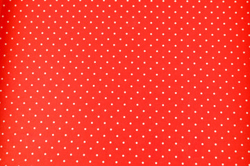 White dots over red Polka dot fabric background and texture. Seamless white and red polka dot...