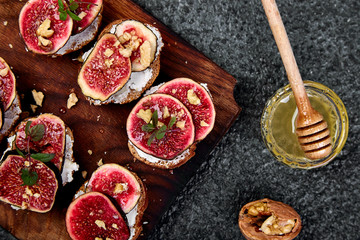 Italian crostini. Bruschetta  or ctostini with cottage cheese, figs and honey. Sandwich with figs and goat cheese.