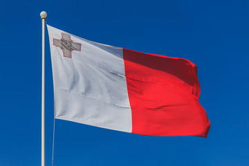 Fototapeta na wymiar Malta national flag is waving in deep blue sky background