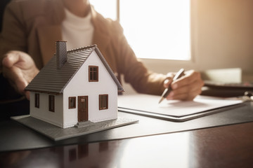 Car and House model with agent and customer discussing for contract to buy, get insurance or loan real estate or property background
