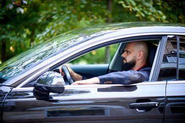 Confident young man driving a car.