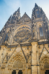 View from below on ancient the St. Vitus Cathedral with a round ornament in center in Prague