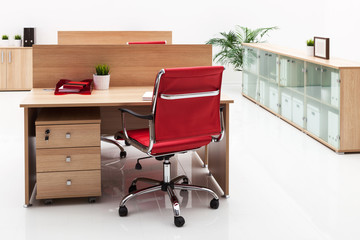 armchair, table and bookcase on white wall