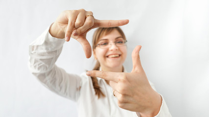 Smiling business Woman Making Frame Gesture, standing at the office. White background. happy office workers concept