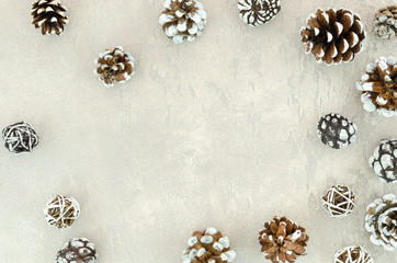 Flat lay frame of pine cones on white textured background. Christmas mockup concept