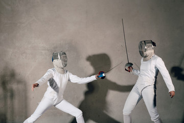 Fencers with fencing sword. Fencers duel concept.