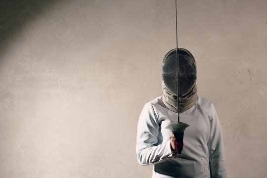 Fencer woman with fencing sword.