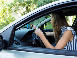 young girl driving in a car on the navigator paves the route