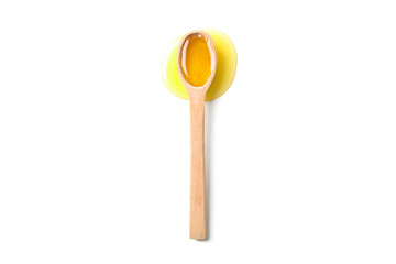 Wooden spoon with honey isolated on white background, top view