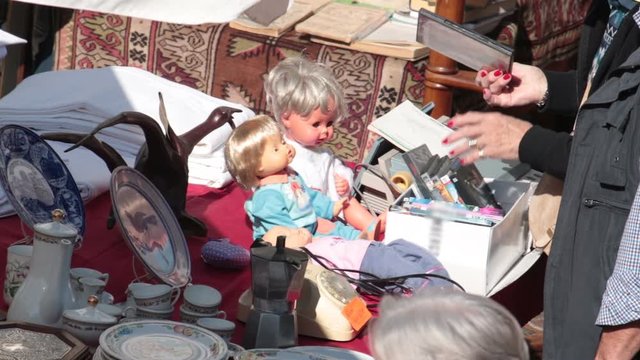 rummaging in a market. Person looking for old dvd