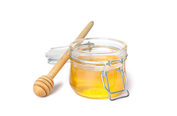 Dipper and glass jar with honey isolated on white background