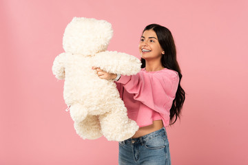 beautiful brunette girl holding teddy bear, Isolated On pink