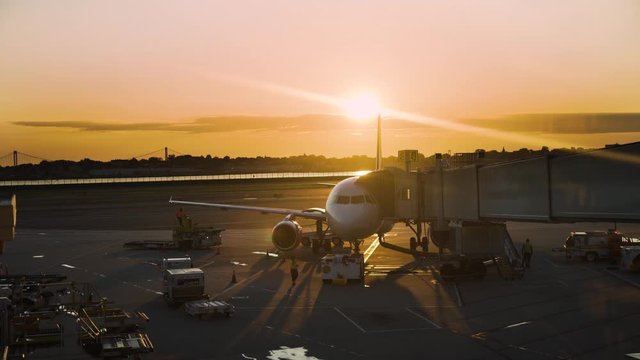 Sunset Airport Terminal. Airplane parked at the airport terminal gate.