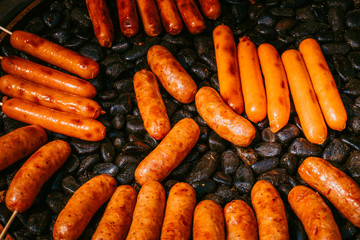 Sausages are on the charcoal grill