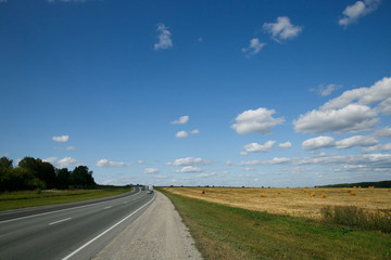 Intercity route passing fields and forests on a summer day