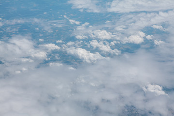 flying above white low clouds