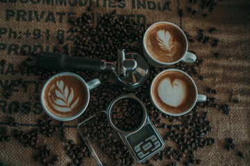 Coffee spoon, modern coffee scale,cup of coffee and coffee grinder on old table