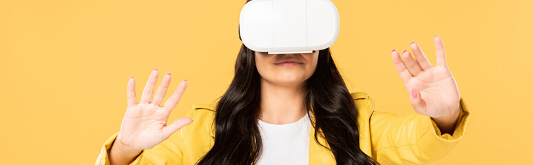 brunette woman using Virtual reality headset, Isolated On yellow