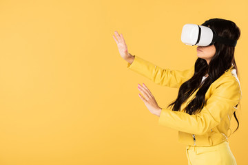 emotional girl using Virtual reality headset, Isolated On yellow