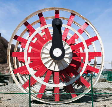Close up of red riverboat paddle wheel.