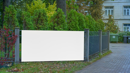 large billboard with place for advertising on large steel fence near house, mock-up - obrazy, fototapety, plakaty