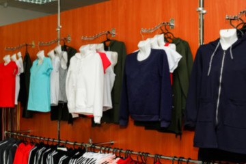 Сlothing boutique store interior blurred background.  Defocused fashion clothing store