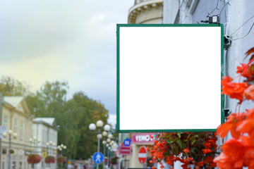 sign with empty white place advertisement of hotel or store on city street, mock-up