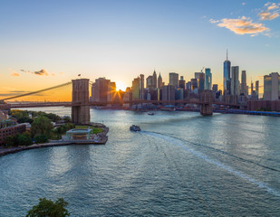 New York City skyline buildings Brooklyn Bridge evening sunset