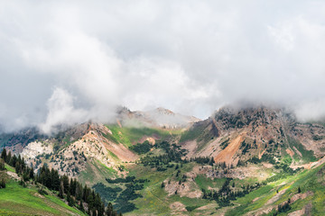Albion Basin, Utah summer morning in 2019 with clouds on stormy day and mist fog covering blanketing rocky Wasatch mountains
